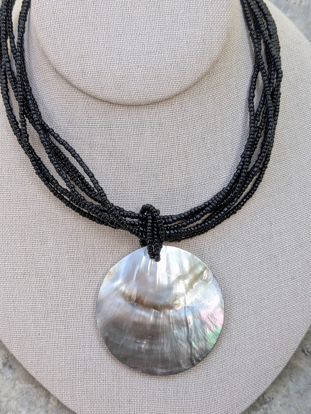 Multi-Strand Black Beaded Necklace with Mother of Pearl Pendant